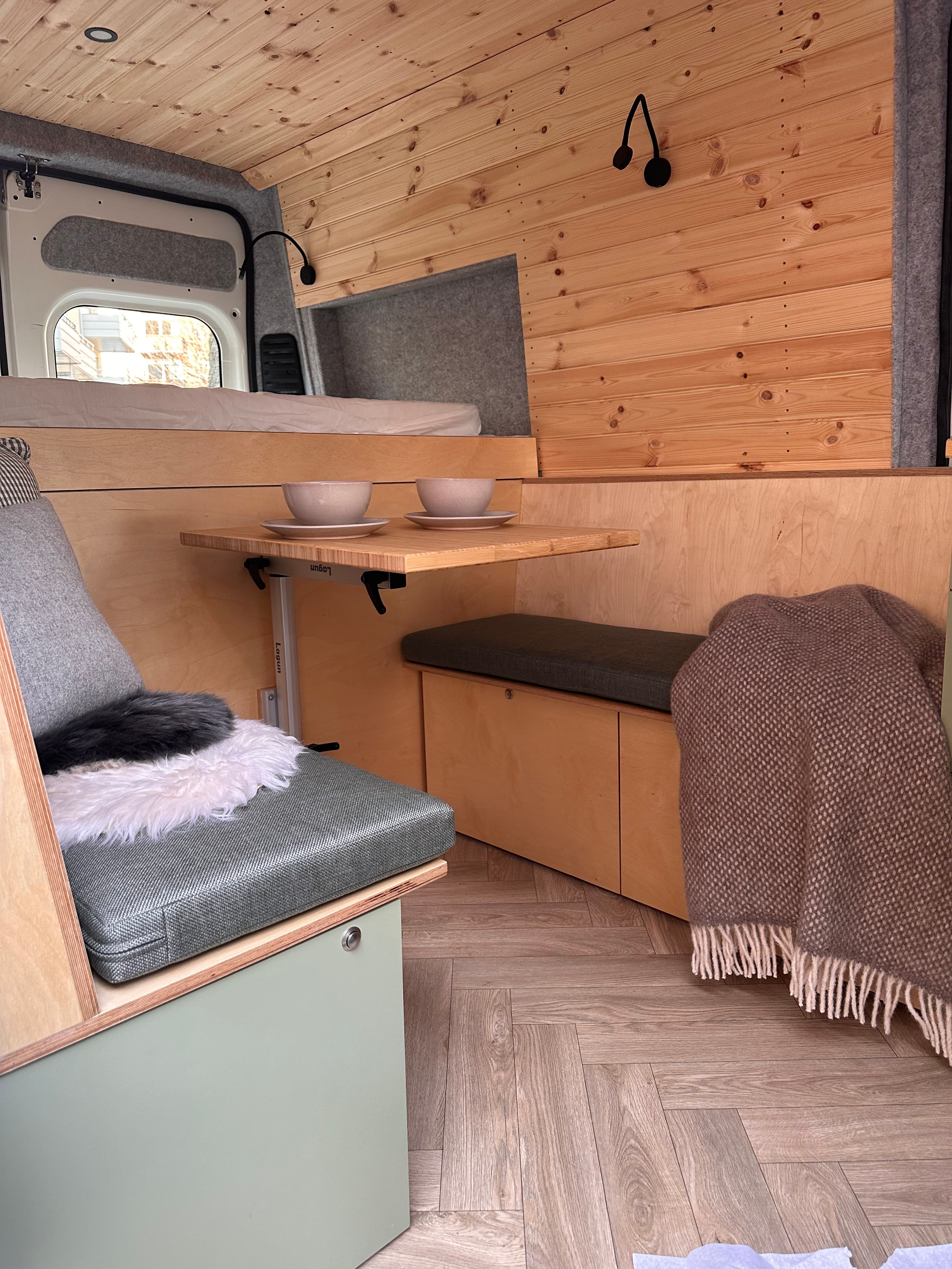 Campervan interior with table setting and dinnerware
